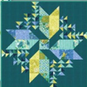 May include: A teal blue quilt with a starburst pattern in shades of blue, yellow, and green. The quilt is made of patchwork fabric and has a geometric design.