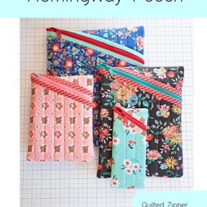 May include: Four quilted zipper pouches in various sizes and floral patterns, including blue, pink, and black. Each pouch features a contrasting zipper and trim. The image includes the text "Hemingway Pouch" and "Quilted Zipper Pouch Pattern in Four Sizes."