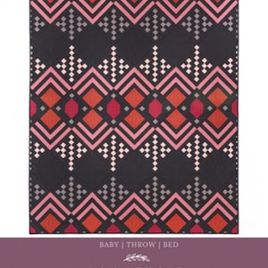 May include: A quilt pattern called "DECO" by Brittany Lloyd. The pattern features a geometric design with red, pink, and gray shapes on a black background. The pattern is available in baby, throw, and bed sizes.