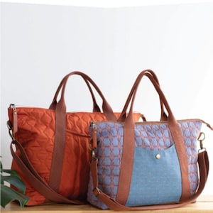 May include: Two Oxbow tote bags in different colors and patterns. One is orange with brown straps, the other is blue with a geometric pattern and brown straps. Both have top zippers and shoulder straps. The text "OXBOW TOTE" is at the top.
