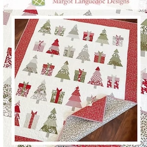 May include: A Christmas-themed quilt featuring a white background with appliqued Christmas trees and gift boxes in various patterns and colors. The quilt has a red border and the text "Christmas Wishes".