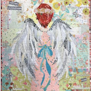 May include: A colorful quilt featuring an angel design. The angel has red hair, a floral crown, and large white wings with text details. The quilt's background is a patchwork of floral and patterned fabrics in pastel colors, with a blue ribbon detail.