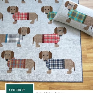 May include: A quilt and pillow pattern featuring dachshund dogs wearing plaid sweaters and glasses. The words "DOGS IN SWEATERS" are at the top. The pattern includes instructions for making two quilt sizes and a pillow cover.