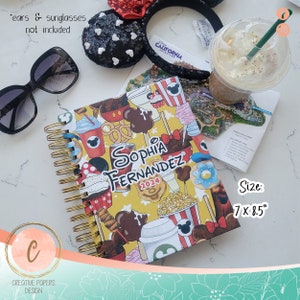 May include: A yellow and red personalized Disney-themed planner with a gold spiral binding. The planner has a Mickey Mouse design and the text "Sophia Fernandez 2024". The planner is 7 inches by 8.5 inches.