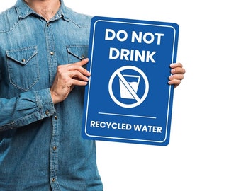 May include: A blue sign with white text that reads "Do Not Drink Recycled Water". A white graphic of a glass of water with a diagonal line through it is in the center of the sign.