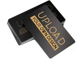 May include: A stack of black plastic cards with gold text that reads "UPLOAD YOUR OWN DESIGN".