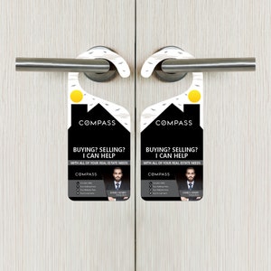 May include: A black and white door hanger with a house silhouette and the text "COMPASS" and "BUYING? SELLING? I CAN HELP" with a photo of a man in a suit and the text "JAMES HENRY" below. The door hanger is designed to be hung on a door handle.