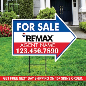 May include: A blue, red and white real estate sign with an arrow pointing to the right. The sign reads "FOR SALE" with the RE/MAX logo and the text "AGENT NAME 123.456.7890".