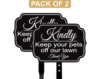 May include: Two black lawn signs with white text saying "Kindly Keep your pets off our lawn Thank You". The signs have a decorative border and are mounted on black stakes. The top of the image reads "PACK OF 2".
