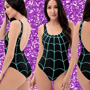 May include: A black swimsuit with a turquoise spiderweb design. The swimsuit has a scoop neck and a low back.