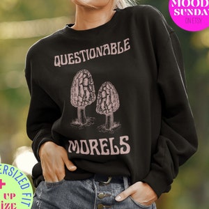 May include: Black sweatshirt with a pink graphic of two morel mushrooms and the text "Questionable Morels".