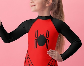 May include: A long-sleeve shirt featuring a red torso with a black spider graphic in the center and black spiderweb patterns at the bottom hem. The sleeves and high neckline are solid black, contrasting with the vibrant red front panel design.