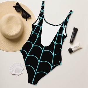 May include: Black swimsuit with a turquoise spiderweb pattern. The swimsuit has a scoop neck and a racerback style.