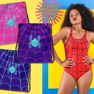 May include: Three drawstring bags featuring a spiderweb pattern and a central spider graphic in pink, purple, and blue, alongside a red one-piece swimsuit with a black spiderweb print. Text reads: CHECK OUT MOODYSUNDAY FOR MORE OPTIONS!