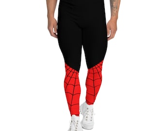 Puede incluir: Leggings negros con un diseño de telaraña roja y negra en la parte inferior de las piernas.