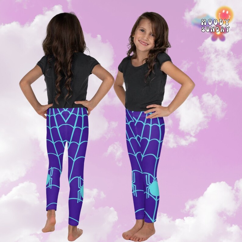 May include: Purple leggings with a blue spiderweb pattern and a turquoise spider on each leg. The leggings are worn by a child standing on a pink and white cloudy background.
