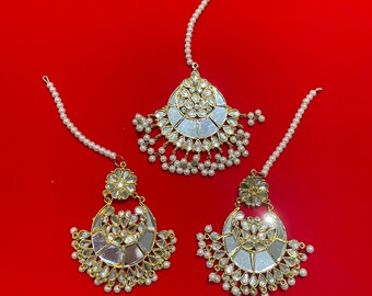 May include: Three gold and silver earrings with pearl accents. The earrings are in the shape of a crescent moon with a mirrored centre.