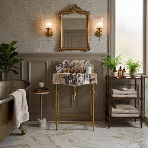 May include: A bathroom vanity featuring a white and purple marble sink basin supported by a gold metal frame. The sink includes gold faucets and is positioned beneath a gold-framed mirror, flanked by two wall-mounted lights in a room with marble floors.