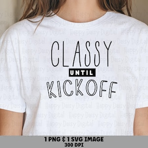 May include: A white short-sleeved t-shirt featuring the black text "CLASSY UNTIL KICKOFF" printed on the front. The word "CLASSY" is in a tall, thin font, "UNTIL" is in a solid black rectangle, and "KICKOFF" is in a bold, outlined font.
