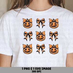 May include: A white t-shirt featuring a repeating grid pattern of orange jack-o'-lantern pumpkins and black and orange bows. The graphic design is arranged in three rows and three columns, alternating between the pumpkin and bow illustrations.