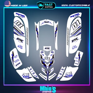 May include: A white and blue motorcycle graphic kit with the words "Procircuit", "Pitster Pro", "Fox", and "Raptor" printed on it. The kit includes a number "01" and a number "X3" graphic.