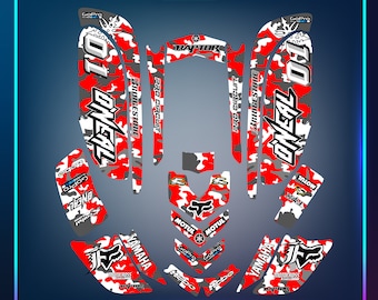 May include: Red, white, and gray camouflage graphic design for a Yamaha Raptor ATV. The design includes the words "Oneal", "Pro Circuit", "Bridgestone", "Motul", and "GoPro".
