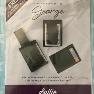 May include: A green leather wallet with three card slots, three pockets, and a money clip. The wallet is labeled "George" and is part of the "Mini Pattern Series" by Sallie Tomato.