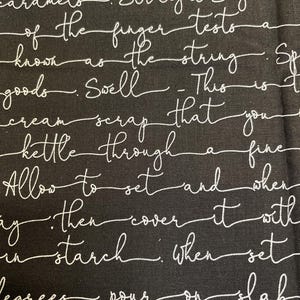 May include: Black fabric with white text that reads: "a batch due to there caramelos. Straight Sugar of the finger tests a known as the string. Spell cream scrap that you kettle through a fine Allow to set and when ay then cover it with in starch: when set degrees pour on slab ough they be red like"