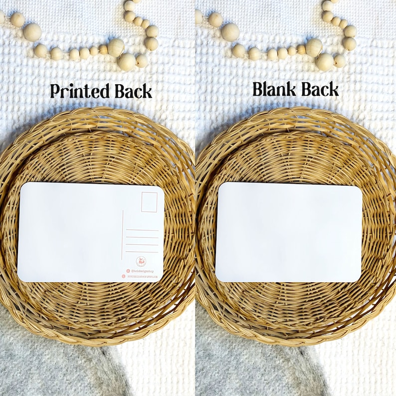 May include: Two blank postcards, one with a printed back and one with a blank back, are displayed on woven wicker coasters. The printed back features a small logo and website address.