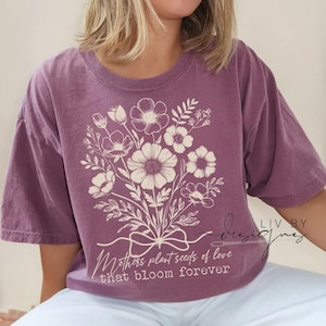 Woman wearing vintage washed Comfort Colors Mother's Day shirt with floral DTF design