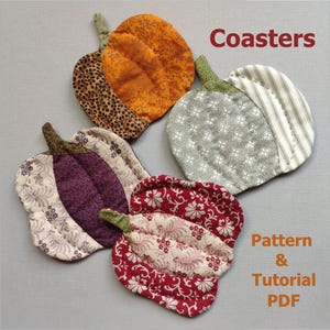 May include: A collection of five handmade, quilted pumpkin-shaped coasters in various patterns and colors. The coasters feature fabrics with floral, striped, and animal print designs. The image includes the text "Coasters" and "Pattern & Tutorial PDF".