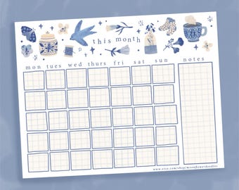 May include: A printable monthly calendar planner with a blue and white floral design. The calendar has spaces for each day of the week, a notes section, and the text "this month".