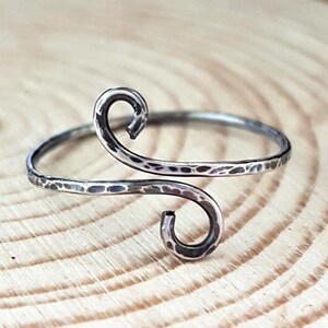 A sterling silver-filled hammered swirl ring. Adjustable size.