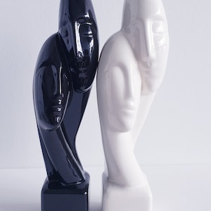 Ceramic statue of man and woman in black or white, known as &#39;Devotion&#39;