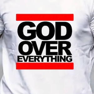 May include: White t-shirt with a black graphic that says "GOD OVER EVERYTHING" with a red stripe above and below the text.