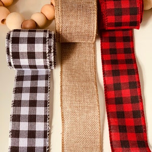 May include: Three different types of ribbon: black and white checkered, brown burlap, and red and black checkered.