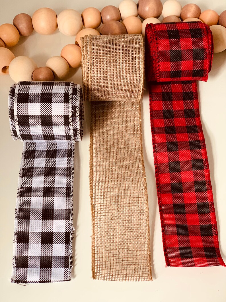 May include: Three different types of ribbon: black and white checkered, brown burlap, and red and black checkered.