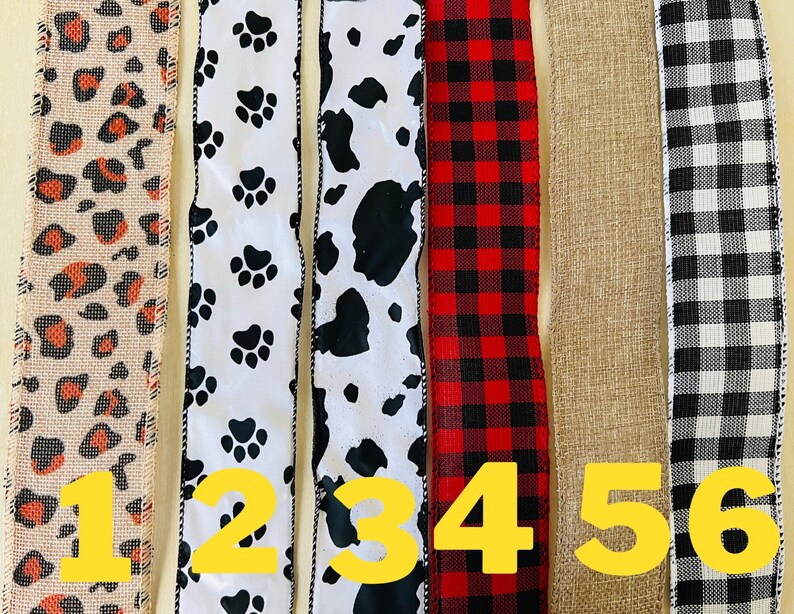 May include: Six different types of ribbon, each with a different pattern. The ribbons are numbered 1 through 6. The patterns include leopard print, paw prints, cow print, plaid, burlap, and gingham.