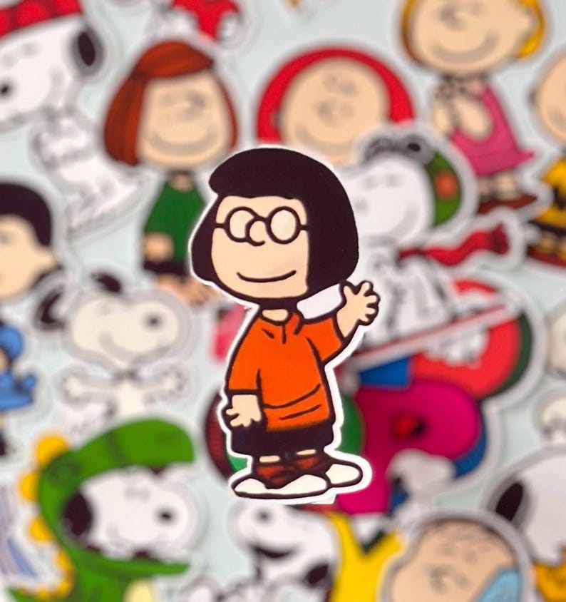 May include: A sticker of a cartoon character with black hair, glasses, and an orange top waving. Other cartoon character stickers surround it, set against a light blue background.
