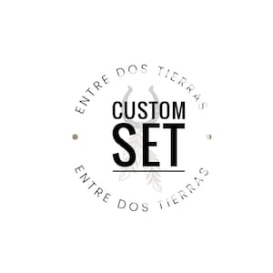 May include: A black and white logo with the text "Entre Dos Tierras" in a circle around the words "Custom Set".