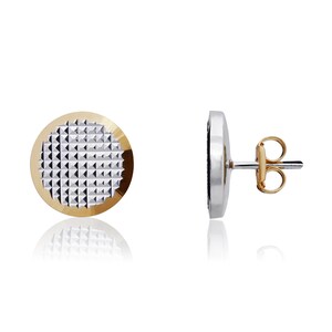 May include: A pair of round stud earrings with a textured silver center and a gold rim. The earrings have a post and butterfly back.