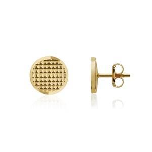 May include: A pair of gold stud earrings with a textured circular design. The earrings have a post and butterfly back.