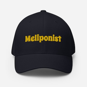 May include: A navy blue baseball cap with the word "Meliponist" embroidered in yellow.