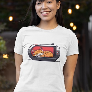 Camiseta unisex con gato en cápsula espacial: camiseta minimalista con lindo gatito naranja soñoliento, camiseta con gatito astronauta de dibujos animados, divertida camiseta para amantes de los animales