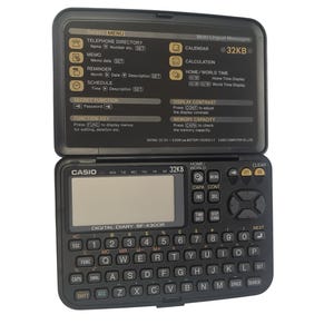 May include: A black Casio Digital Diary SF-4300R electronic organizer with an open clamshell design. It features a small keyboard, a display screen, and various function buttons. The top section displays menu options and the text "Multi-Lingual Messages".