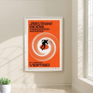 May include: A vintage movie poster for the film "Vertigo" starring James Stewart and Kim Novak. The poster features a swirling spiral design in orange and white with a silhouette of a man running in the center. The text "60th Anniversary" is at the bottom of the poster.