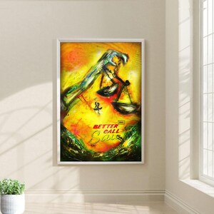 May include: A yellow, green, and red abstract painting of a hand holding a scale of justice. The text "Better Call Saul" is written in red and yellow on the bottom of the painting. The painting is framed in a white frame.