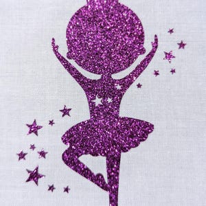 Könnte beinhalten: Eine lila glitzernde Ballerina-Silhouette mit einem Dutt und einem Tutu, umgeben von kleinen lila glitzernden Sternen.
