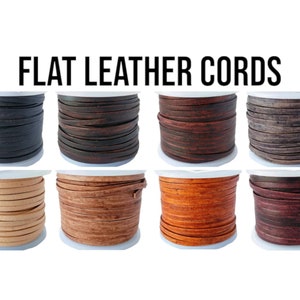 May include: Eight spools of flat leather cord in various colours, including black, brown, beige, orange, and burgundy. The spools are labelled "FLAT LEATHER CORDS".