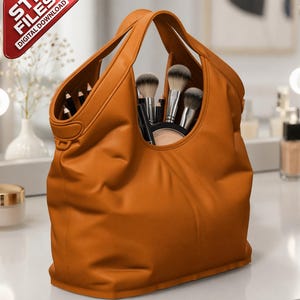 May include: A large, orange leather tote bag filled with makeup brushes, pencils, and a compact. The bag has two handles and is sitting on a white surface. A red triangle in the corner reads "STL FILES DIGITAL DOWNLOAD."